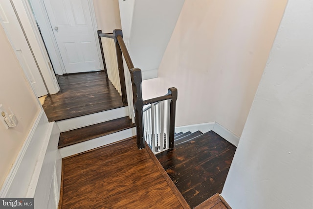 stairs featuring baseboards and wood finished floors