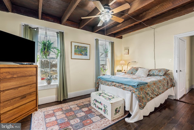 bedroom with beam ceiling, multiple windows, baseboards, and hardwood / wood-style floors