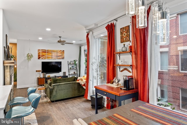 living area with a ceiling fan, wood finished floors, and recessed lighting