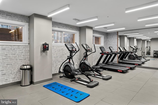 workout area with brick wall and visible vents