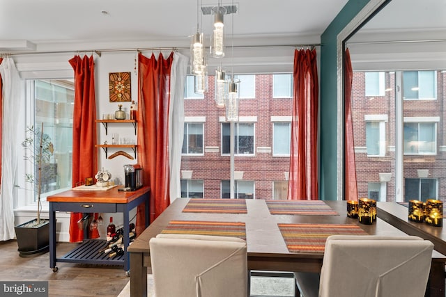 dining space featuring visible vents and wood finished floors