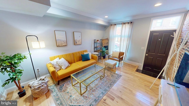 living room with recessed lighting, crown molding, baseboards, and wood finished floors