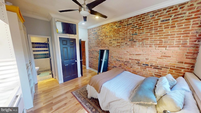 bedroom with ensuite bath, brick wall, ceiling fan, light wood-style flooring, and crown molding