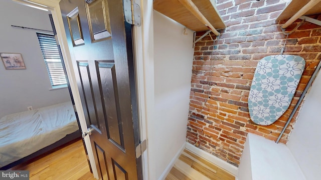 interior space featuring baseboards and wood finished floors