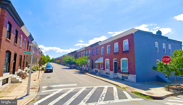 view of street featuring sidewalks, traffic signs, and curbs