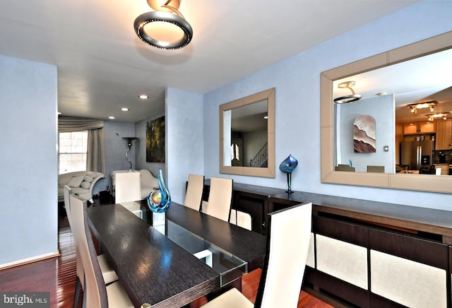 dining room featuring wood finished floors and recessed lighting