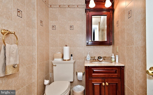 half bath featuring toilet, tile walls, and vanity