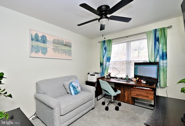 carpeted office with a ceiling fan