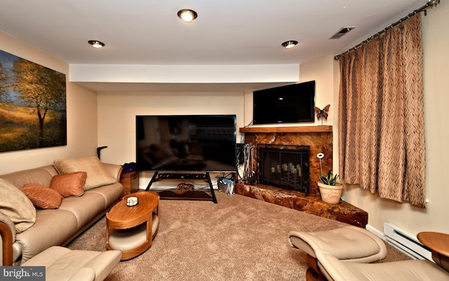 carpeted living area with a fireplace with raised hearth, a baseboard radiator, and visible vents