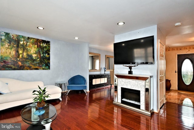 living area featuring wood-type flooring, a fireplace, and recessed lighting