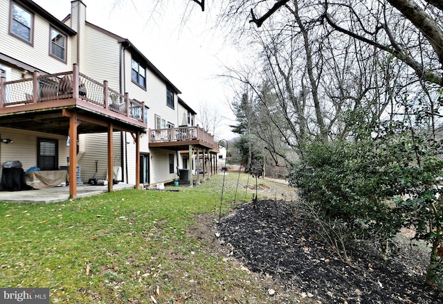 view of yard featuring a deck and a patio area