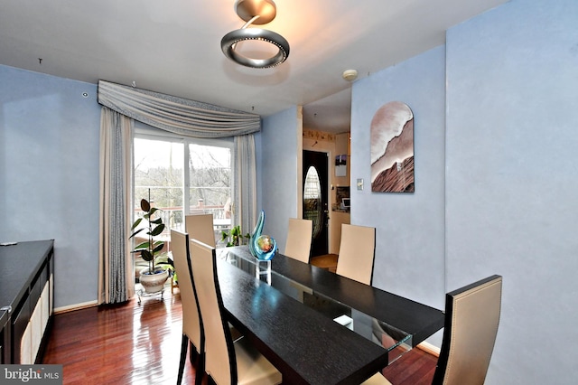 dining area featuring baseboards and wood finished floors