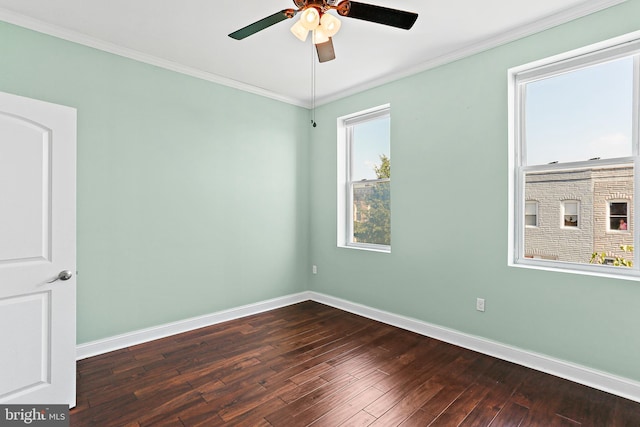 unfurnished room featuring baseboards, ceiling fan, dark wood-style flooring, and crown molding