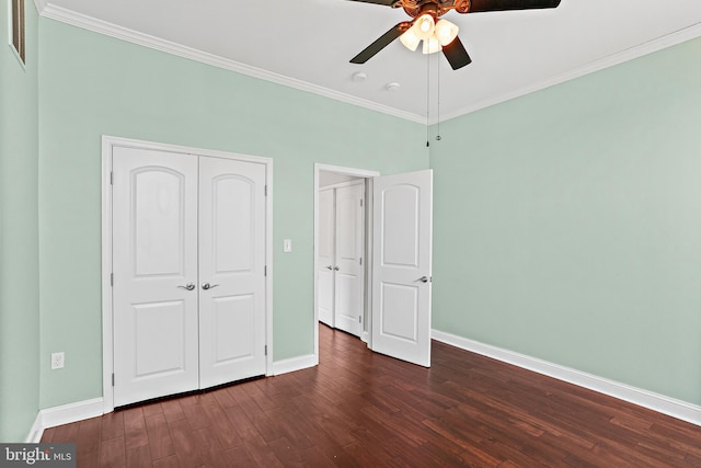 unfurnished bedroom with crown molding, dark wood finished floors, and baseboards