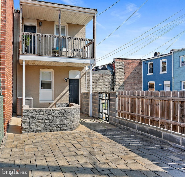 exterior space with central AC, fence, and a balcony