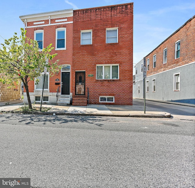 view of property featuring brick siding