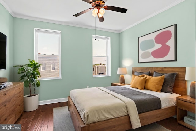 bedroom featuring dark wood-type flooring, ornamental molding, baseboards, and ceiling fan