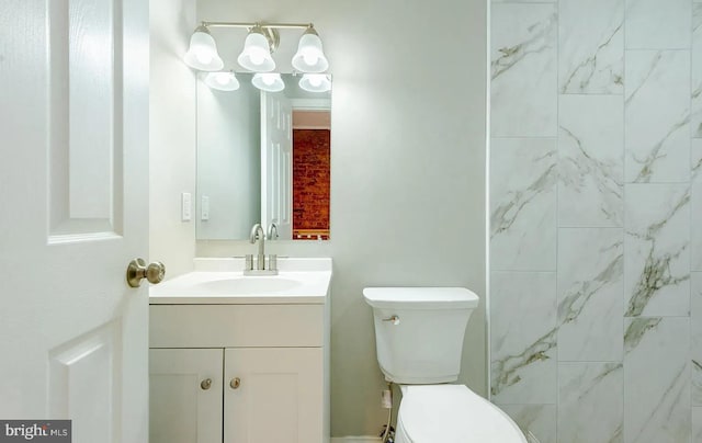 bathroom featuring toilet and vanity