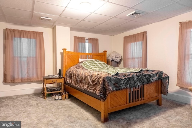 bedroom featuring a paneled ceiling, carpet, and visible vents