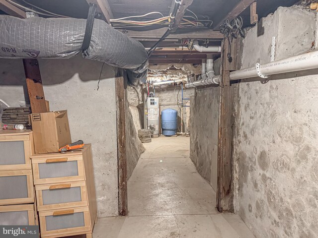 unfinished below grade area featuring water heater