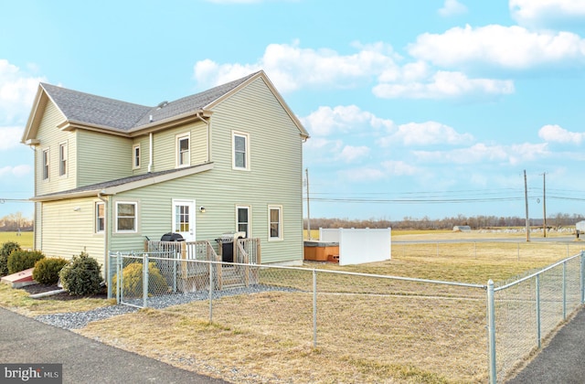 view of side of home with fence private yard and roof with shingles