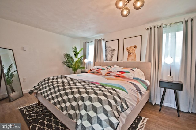 136 W Lytle Ave, State College, PA 16801 - bedroom featuring wood finished floors, baseboards, and a chandelier