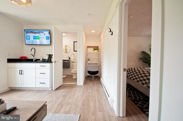 136 W Lytle Ave, State College, PA 16801 - hallway with a baseboard radiator, light wood-style floors, baseboards, a sink, and recessed lighting