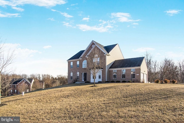 traditional-style home with a front yard and brick siding