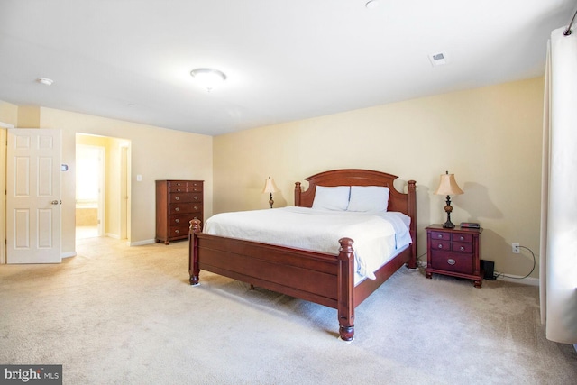 bedroom featuring light carpet, visible vents, and baseboards