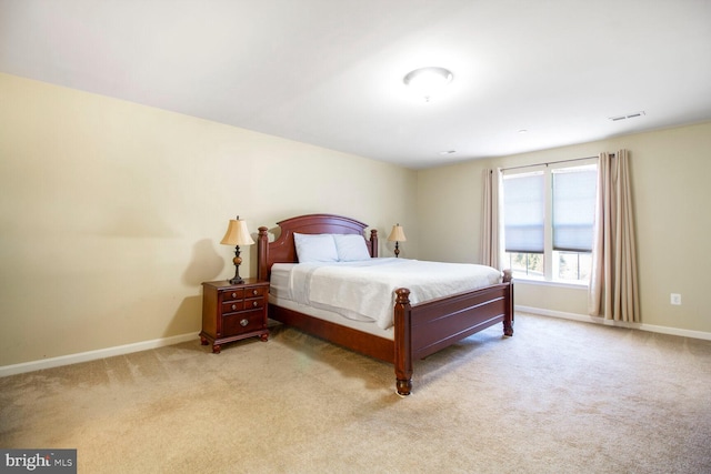 carpeted bedroom with visible vents and baseboards