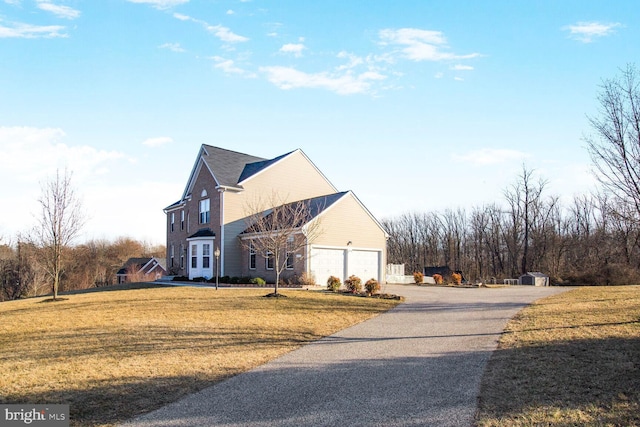 view of home's exterior featuring a garage, aphalt driveway, and a lawn