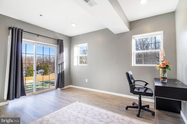 office with visible vents, baseboards, and wood finished floors