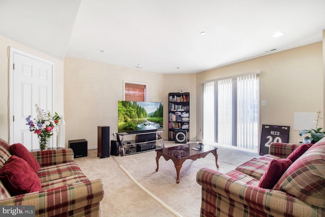 carpeted living area with visible vents and recessed lighting