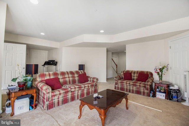 carpeted living area featuring stairs and recessed lighting