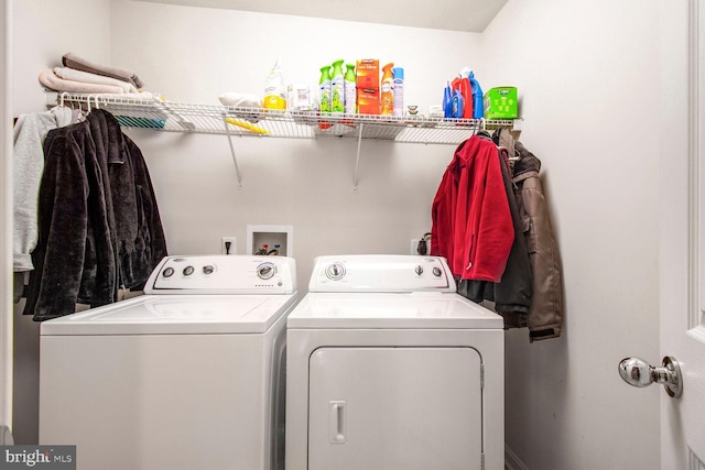 clothes washing area featuring laundry area and separate washer and dryer