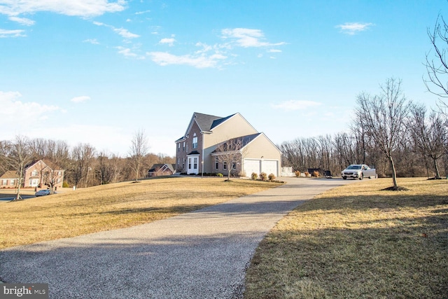 exterior space with a garage, driveway, and a lawn