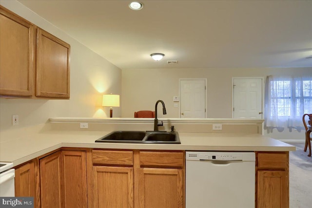 kitchen featuring a peninsula, white dishwasher, a sink, light countertops, and brown cabinets