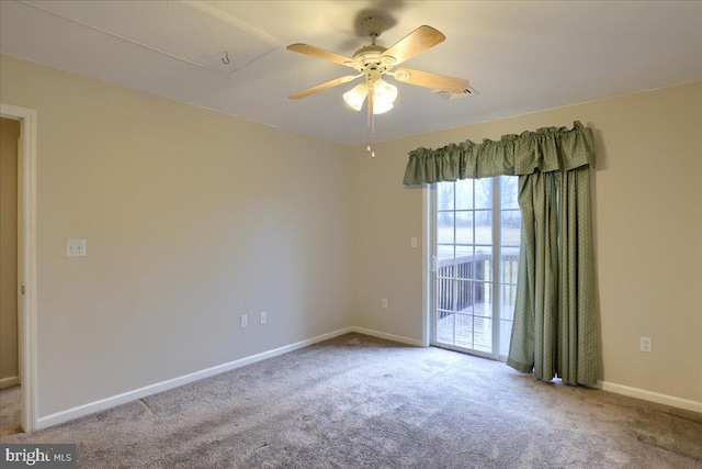 unfurnished room with visible vents, baseboards, carpet, and a ceiling fan