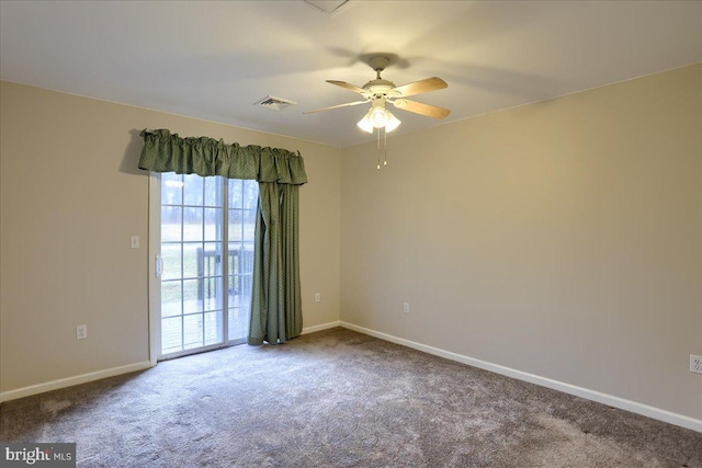 empty room featuring carpet flooring, baseboards, and visible vents