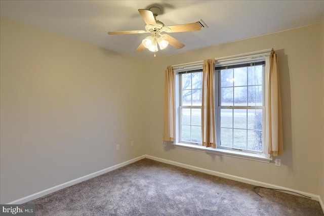 unfurnished room featuring carpet flooring, baseboards, and ceiling fan