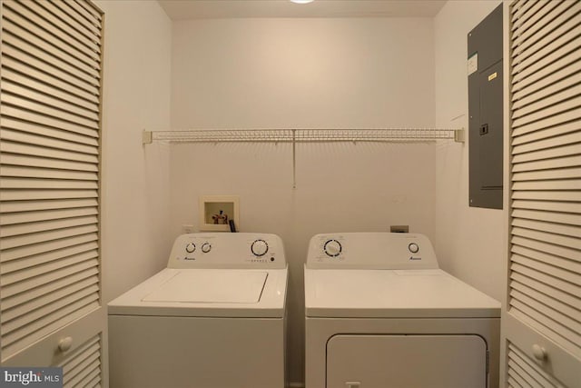 clothes washing area featuring washer and clothes dryer and laundry area