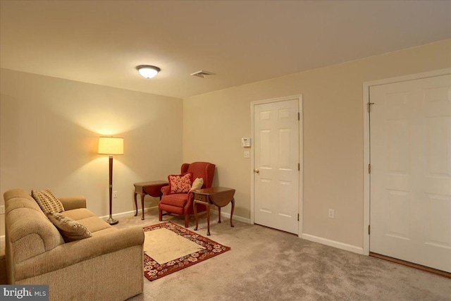 living area featuring visible vents, carpet floors, and baseboards