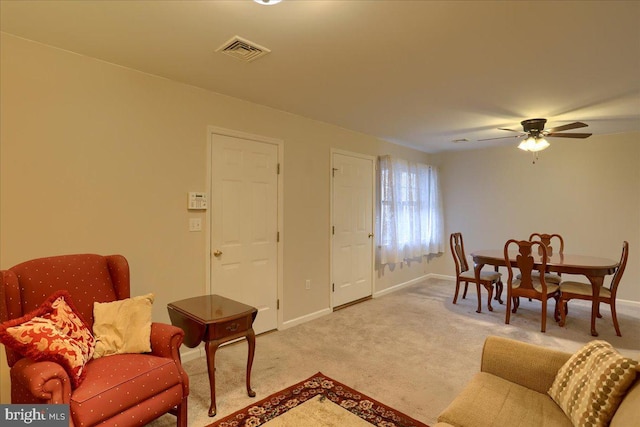 living area featuring visible vents, carpet floors, and baseboards