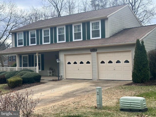 view of front of house featuring covered porch, concrete driveway, and roof with shingles