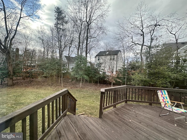 wooden deck featuring a yard