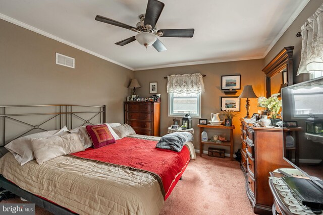 bedroom with ceiling fan, light colored carpet, visible vents, baseboards, and crown molding