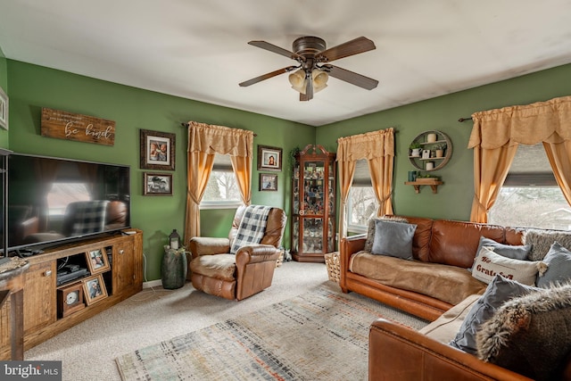 living area with a healthy amount of sunlight, carpet, and ceiling fan