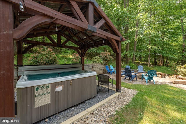 view of patio with a gazebo, an outdoor fire pit, and a hot tub