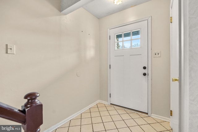 foyer entrance featuring baseboards and light tile patterned flooring