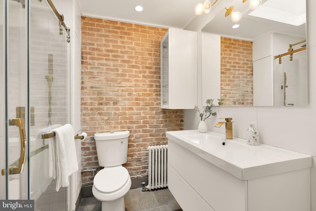 full bath featuring brick wall, toilet, vanity, and radiator heating unit